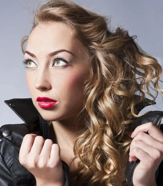 Beautiful slim sexy blond, girl in leather jacket — Stock Photo, Image