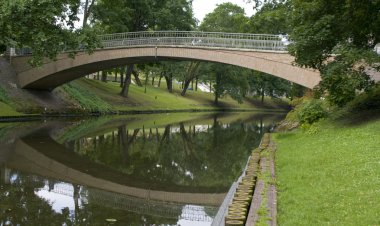 Bridge in City park in centre of Riga clipart