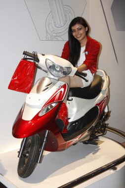 A model displaying a Two Wheeler at Auto Expo 2012 clipart