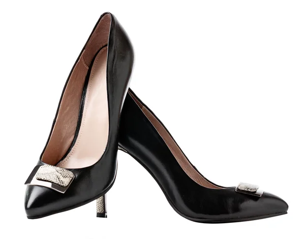 Svarta kvinnliga skor över vita — Stockfoto