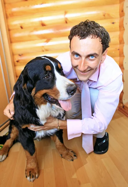 Young man with his bernese sennenhund dog — Stock Photo, Image