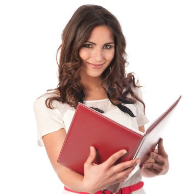 Young cute business woman with a book in her hands clipart