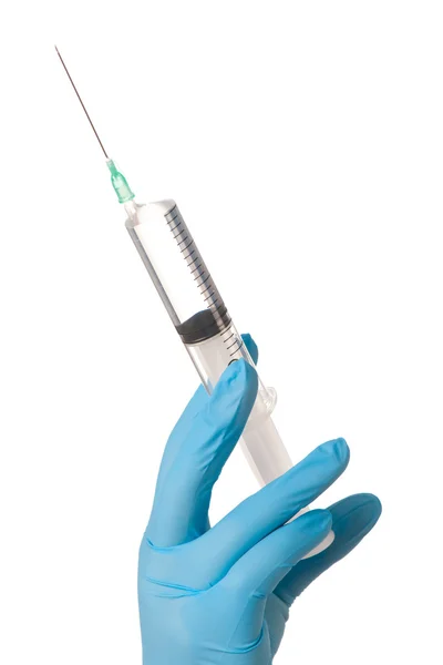 Hand in glove with medical syringe. — Stock Photo, Image