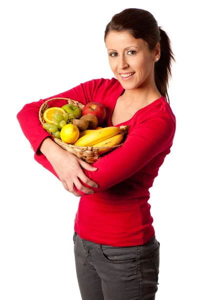 Attraktive junge Frau mit Korb mit verschiedenen Früchten — Stockfoto