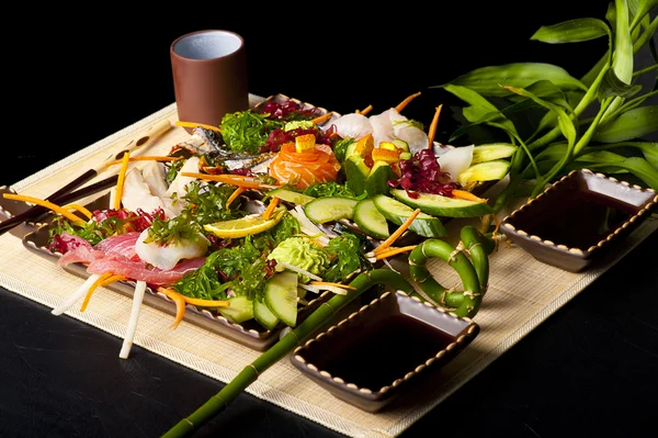 Mixed sashimi, raw fish with seaweed — Stock Image Mixed sashimi, raw fish with seaweed Stock Photo