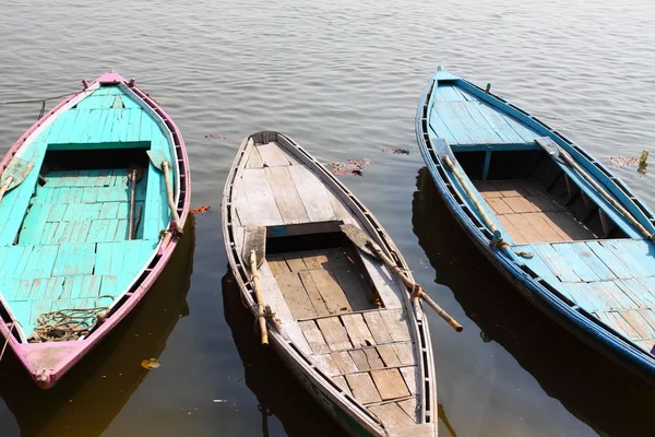 Colorful boats on brown waters of Ganges river, Varanasi, India Royalty Free Stock Photos