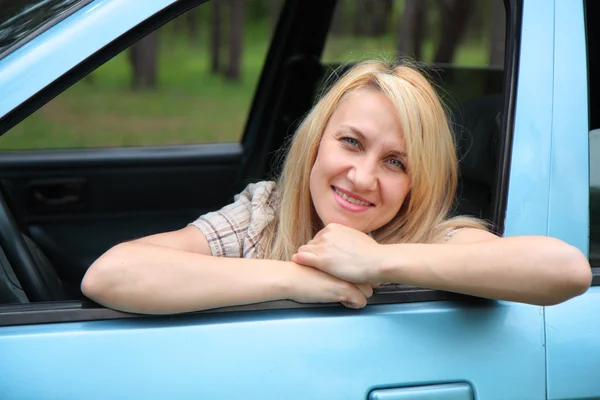 stock image Smiling young woman in the car