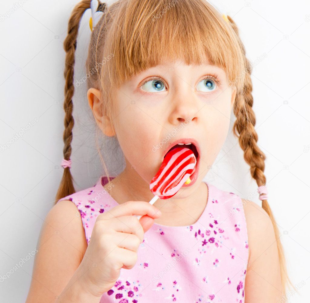 A girl looks up with candy
