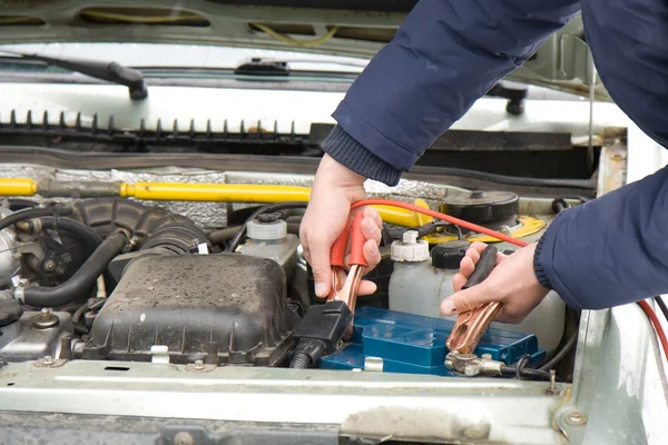 A mechanic using jumper cables — Stock Photo, Image