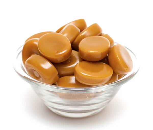 Caramel candies in glass bowl — Stock Photo, Image