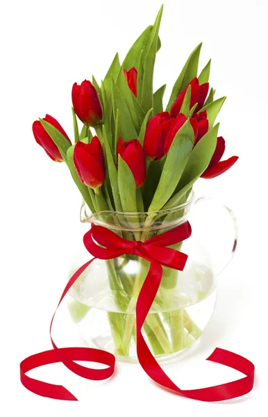Red tulips in a vase with a red ribbon — Stock Photo, Image
