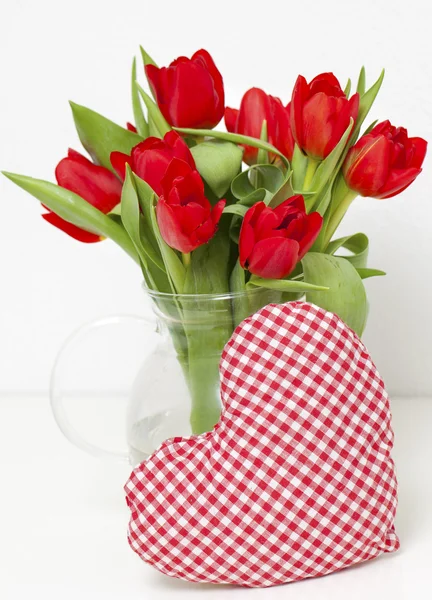 Tulipanes rojos atados con una cinta roja — Foto de Stock