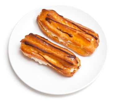 Two eclairs on a white plate clipart