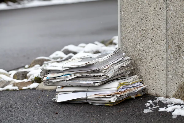 stock image Stack of newspaper on a winter street