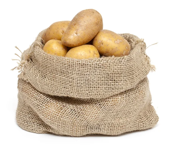 Batatas em um saco de serapilheira — Fotografia de Stock