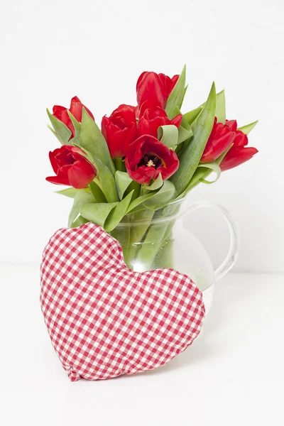Tulips and heart-shaped pillow — Stock Photo, Image