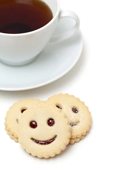 Xícara de chá e biscoitos sorridentes — Fotografia de Stock