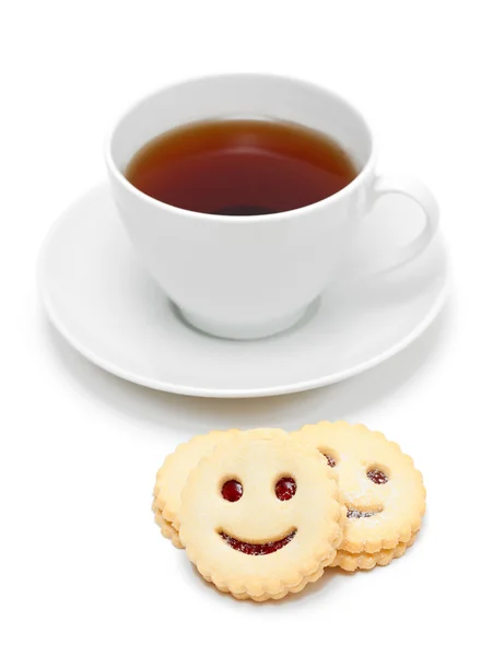 Cup of tea with smiling cookies — Stock Photo, Image
