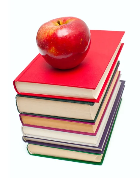 Manzana en la pila de libros aislados en blanco — Foto de Stock