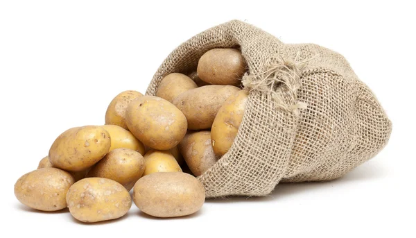 Patatas en una bolsa de arpillera Fotos de stock