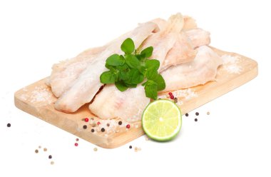 Frozen pollock (pallock) on cutting board isolated clipart