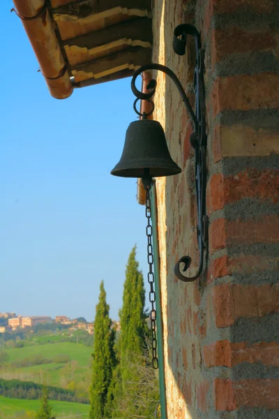 Colorful door bell with a wall of Tuscanian house