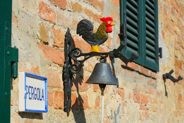 Colorful door bell with a cock on a wall of Tuscanian house — Stock Photo, Image