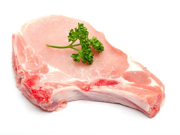 Кусок мяса и веточка петрушки — стоковое фото