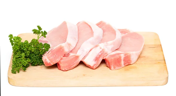 Trozos de carne y manojo de perejil en la tabla de cortar aislado en — Foto de Stock