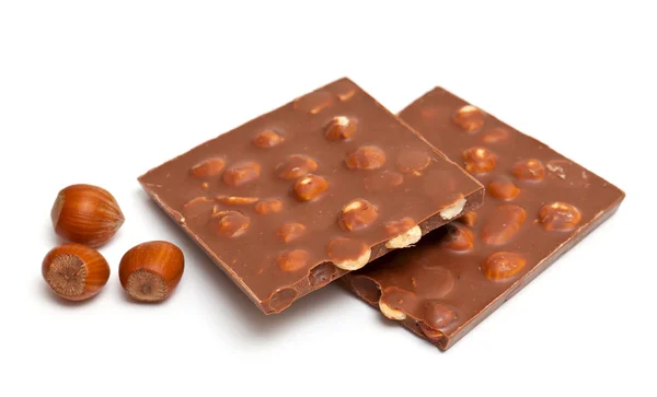Milk chocolate with hazelnuts isolated on white — Stock Photo, Image