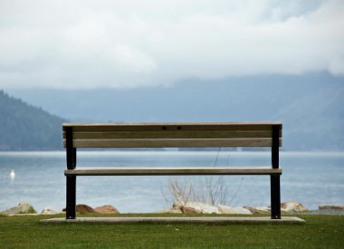 Empty bench facing Harrison lake clipart