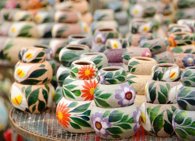 Bunch of Mexican ceramic pots on a market table clipart