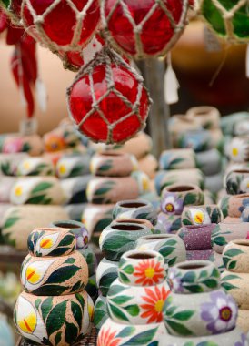 Bunch of Mexican ceramic pots on a market table clipart