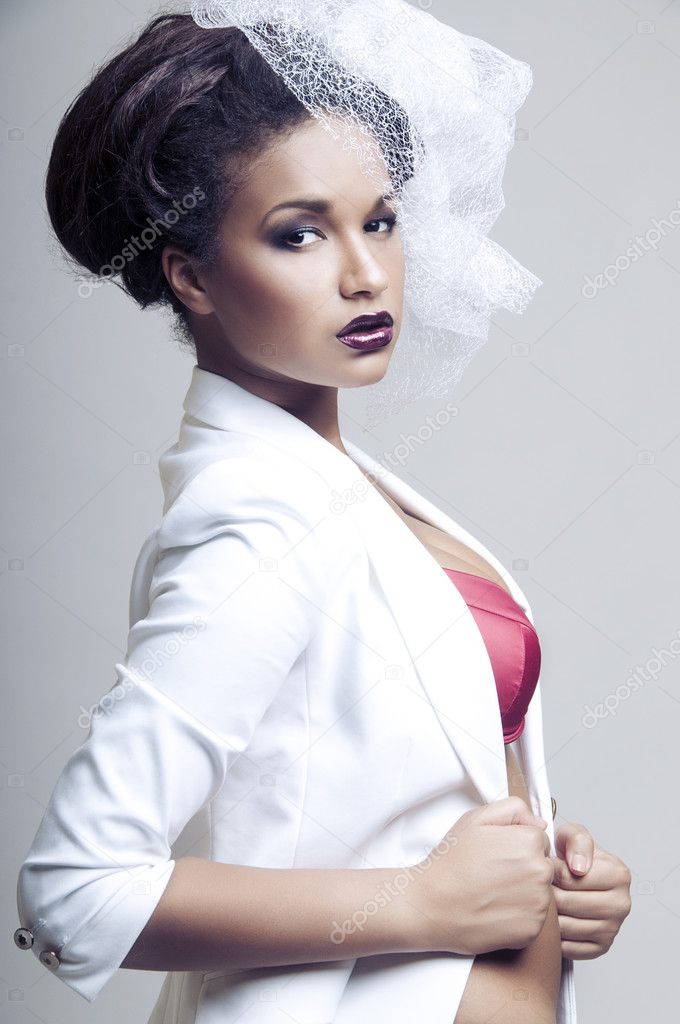 Sexy african woman posing in white fop on light grey background