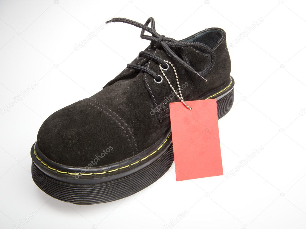 Sale sign and black shoe with