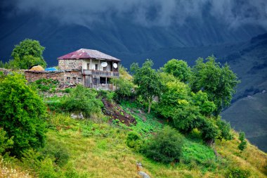 The house in the mountainous near Gudauri (Georgia). clipart