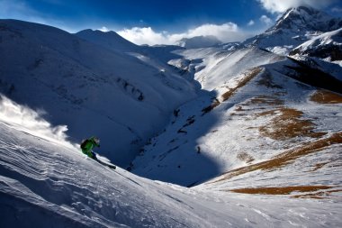 Freerider on the background of Mount Kazbek clipart