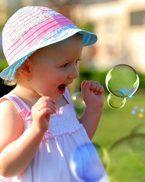 Little girl having fun with soap bubbles — Stock Photo, Image