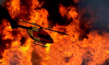 Orman yangını ile uçan helikopter