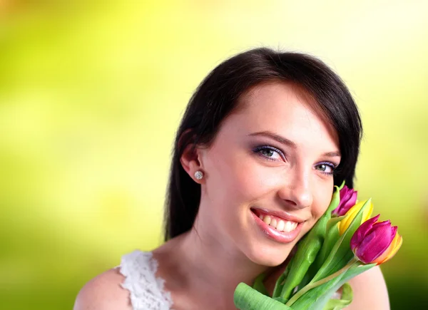 Young woman holding tulips — Stock Photo, Image