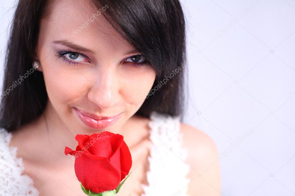 Young woman holding a rose