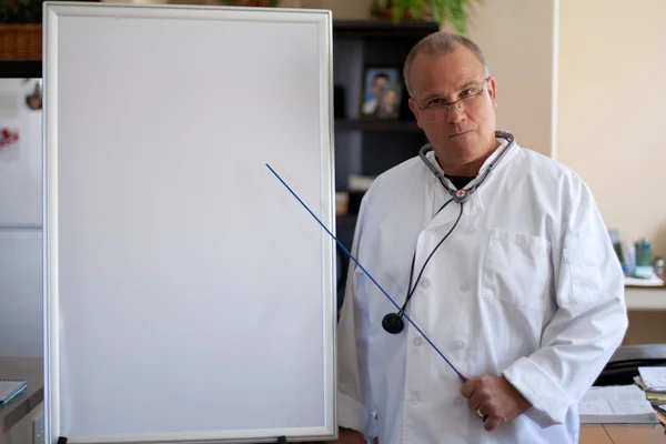 Doctor with blackboard pointing — Stock Photo, Image