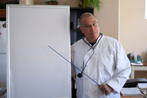 Doctor with blackboard pointing — Stock Photo, Image