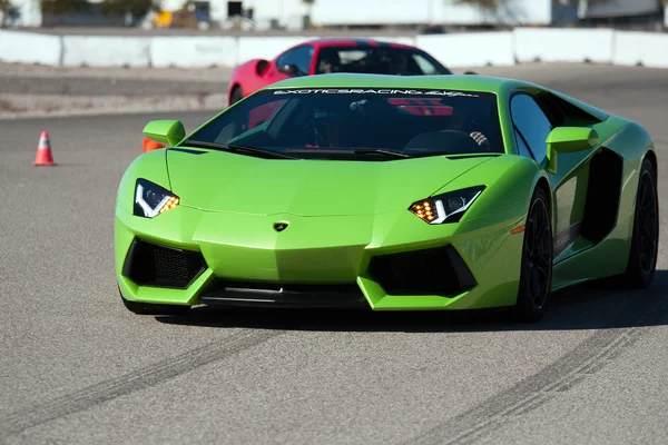 stock image Green ItalianLamborghini car on track