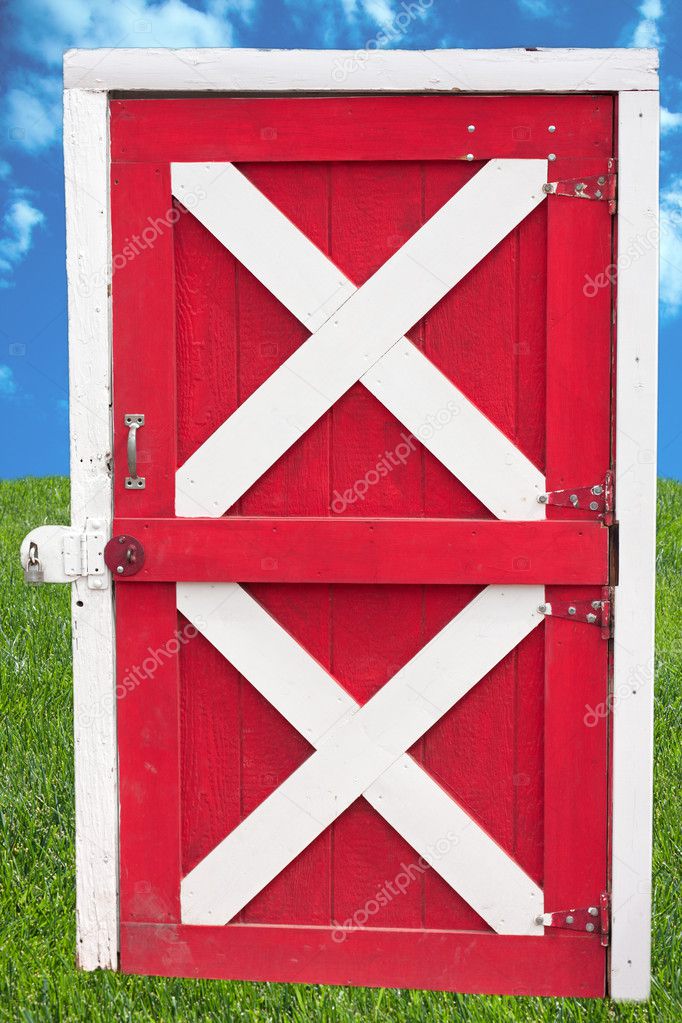 Barn door on sky and grass