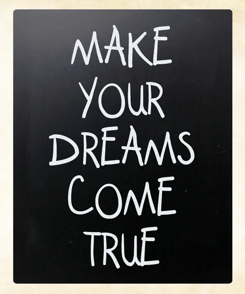 "Make your dreams come true "handwritten with white chalk on a b — стоковое фото