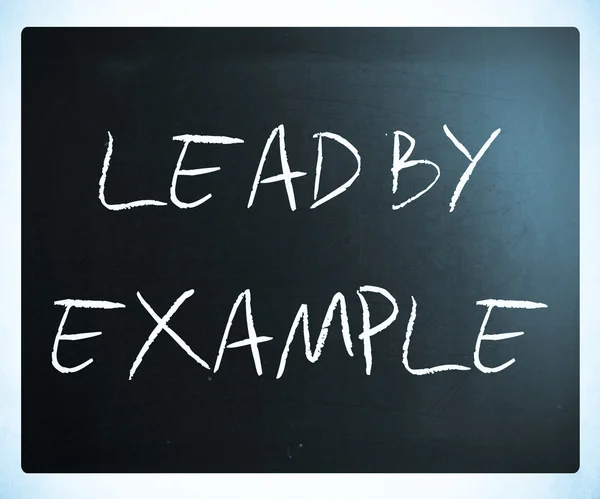 "Lead by example" handwritten with white chalk on a blackboard — Stok fotoğraf