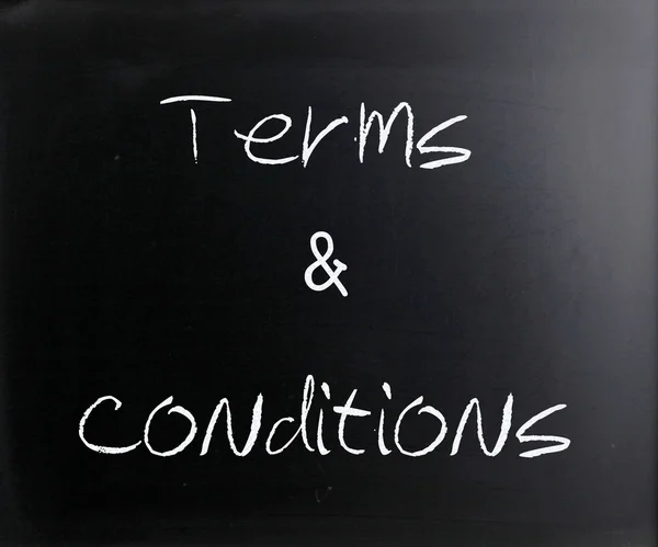 "Terms & Conditions" handwritten with white chalk on a blackboar — Stock Photo, Image