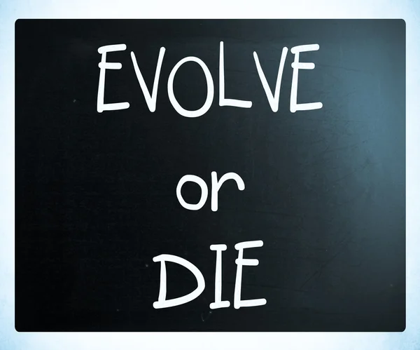 "Evolve or Die" handwritten with white chalk on a blackboard — Stock Photo, Image