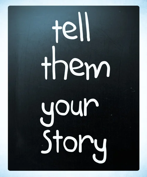 "Tell them your story" handwritten with white chalk on a blackbo — Stock Photo, Image
